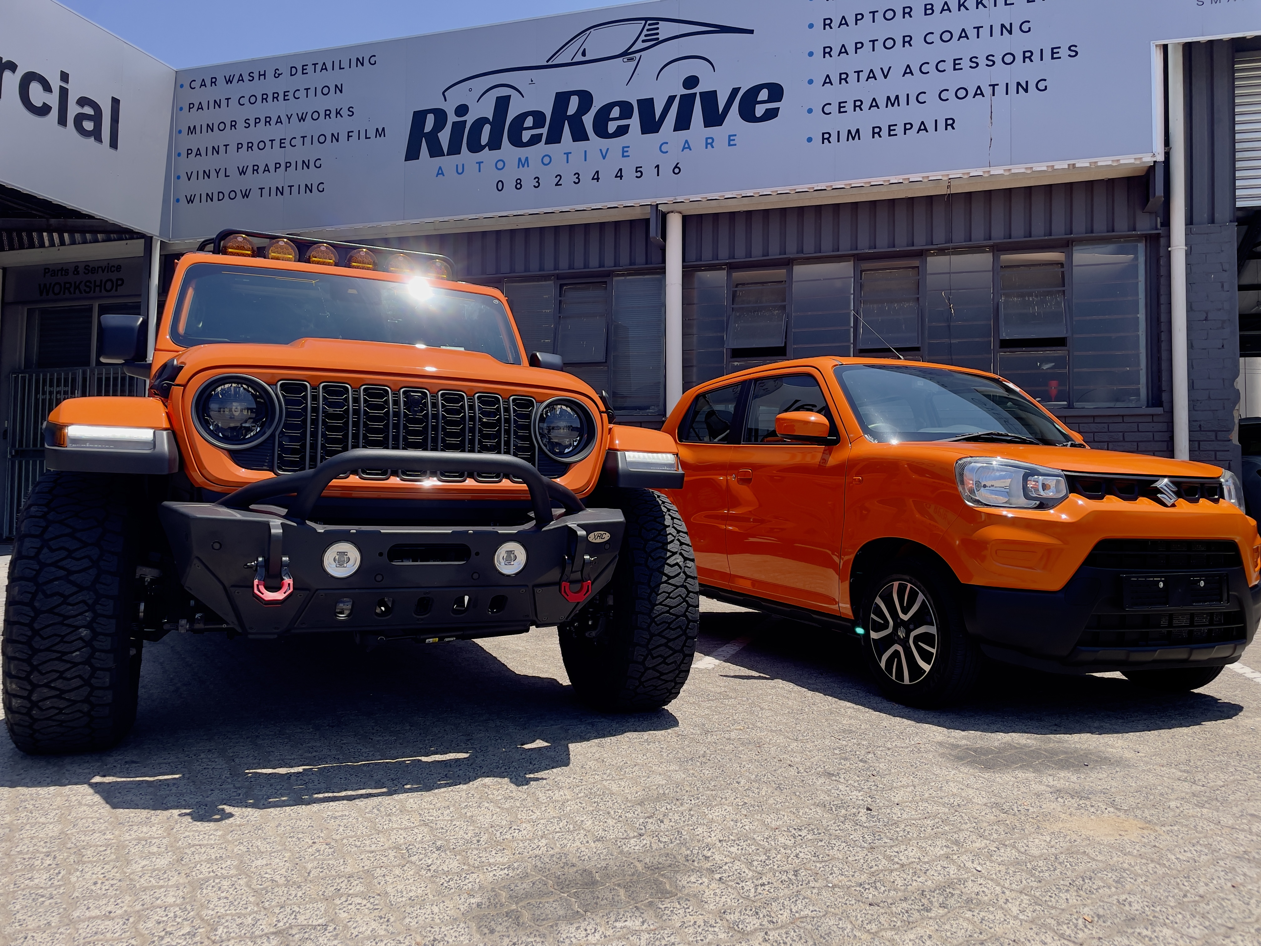 Two custom orange vehicles parked in front of the Ride Revive Automotive Care storefront in Paarl